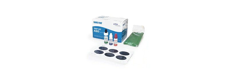 A box of medical supplies containing vials, a test strip, and a tray with circular wells.